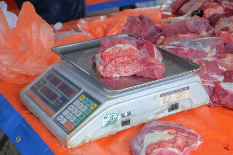 Beef was weighed before being distributed to the poor muslims in needs during 写真素材