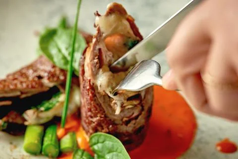 Beef wellington with cheese inside, asparagus and sauce. Close-up. Selective  Stock Photos