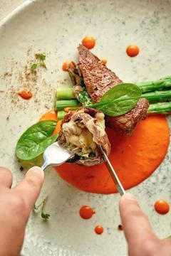 Beef wellington with cheese inside, asparagus and sauce. Close-up. Selective  Stock Photos