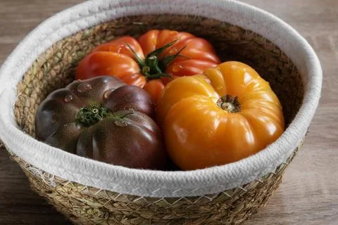 Beefsteak tomatoes in a basket Stock Photos