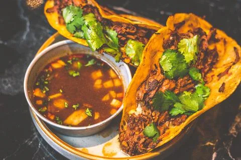 Beefy Birria Tacos made using 8 hour slow cooked chuck with beef consomm on.. Stock Photos