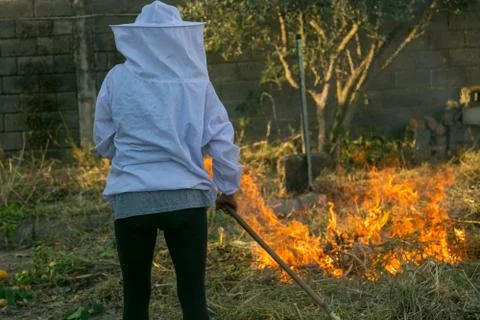 Beekeeper with fire to make smoke Stock Photos