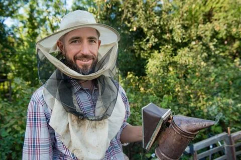 Beekeeper in a protective mask smiling Stock Photos