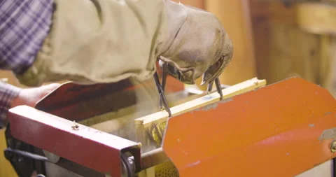 Beekeeper remove honey bees from honeycomb with machine, slow motion shot. Stock Footage 132487276