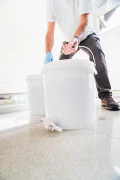 Beekeeper Taking Two White Buckets Filled with Freshly Harvested Bee Honey Stock Photos