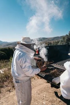 Beekeepers preparing material to go collect honey from the honeycombs Stock Photos