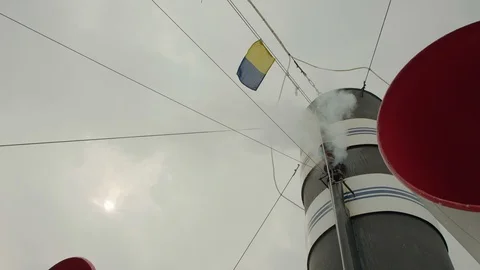 Beep on ship with steam exiting next to a black and white pipe in cloudy weather Stock Footage 129043910