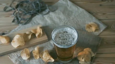 Beer and potato chips on the table. Oktoberfest theme. Slow Motion. Stock Footage 80273190