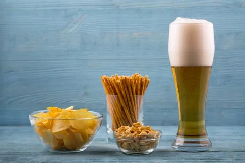 Beer and snacks, chips, bread sticks and peanuts Stock Photos