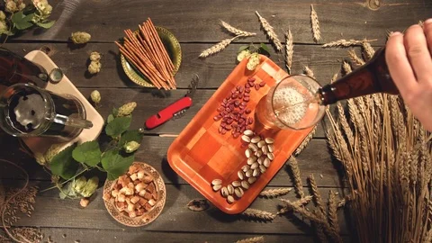 Beer and a variety of snacks on the table. Видео 79866923