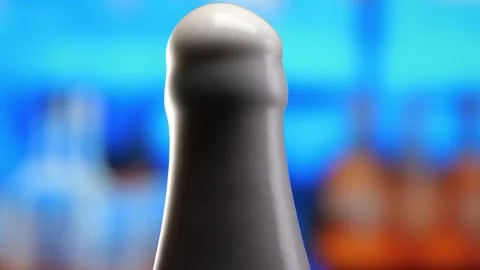 Beer in a beer bottle, forming bubbles and a frothy head. Beer foam flows down Stock Footage 259382502
