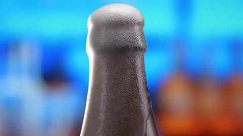 Beer in a beer bottle, forming bubbles and a frothy head. Beer foam flows down Stock Footage 278597286