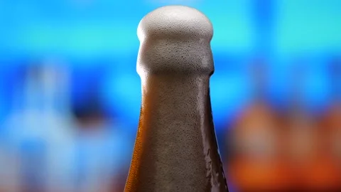 Beer in a beer bottle, forming bubbles and a frothy head. Beer foam flows down Stock Footage 279485536