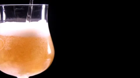 Beer being poured on a black background Stock Footage 8509920