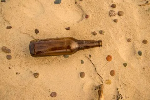Beer bottle on a beach Stock Photos