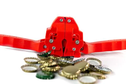 BEER BOTTLE CANNER, SURROUNDED BY PLATES READY TO PREPARE CRAFT BEER Stock Photos