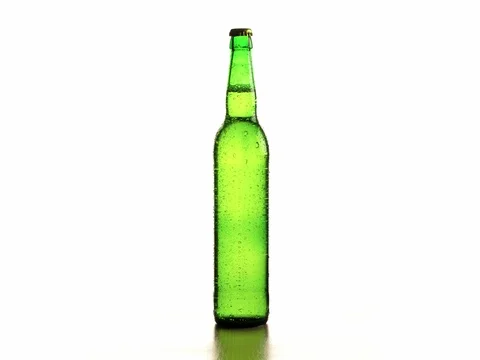 Beer bottle with drops isolated on white background 4k video. Cold wet brew Stock Footage 83142911