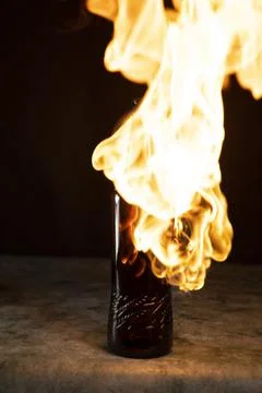 Beer bottle in fire and flame Stock Photos