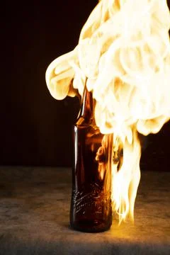 Beer bottle in fire and flame Stock Photos