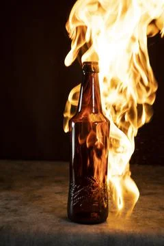 Beer bottle in fire and flame Stock Photos