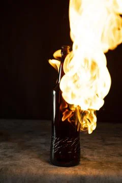 Beer bottle in fire and flame Stock Photos