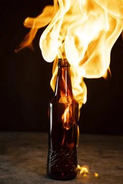 Beer bottle in fire and flame Stock Photos
