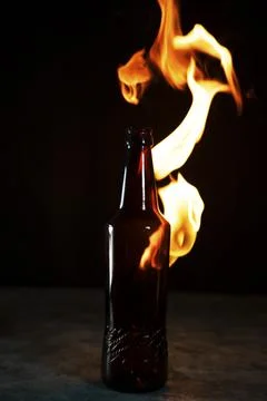 Beer bottle in fire and flame Stock Photos