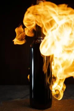 Beer bottle in fire and flame Stock Photos