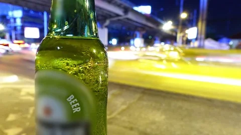 Beer bottle on roadside night time lapse Stock Footage 78535785