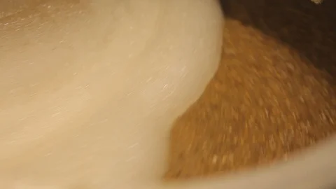 Beer is brewed and fermented in large aluminum tanks. Foam on the surface. Stock Footage 113524146