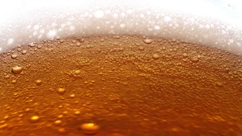 Beer bubbles with foam in golden light Stock Footage 118614844