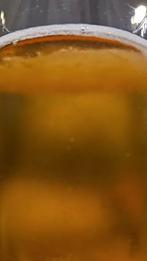 Beer with bubbles in the glass from close distance Stock Footage 248966971