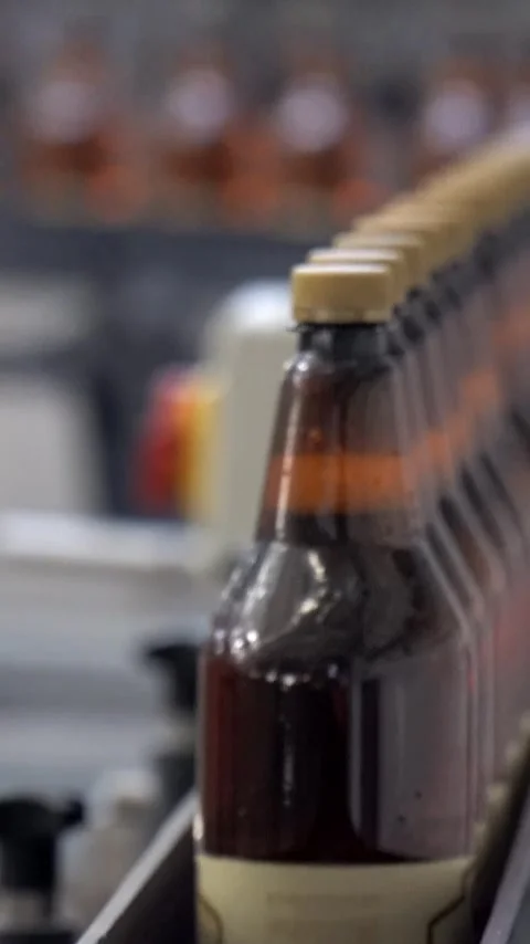 Beer cans are moving along the conveyor beltTechnological line for bottling of Stock Footage 310632547