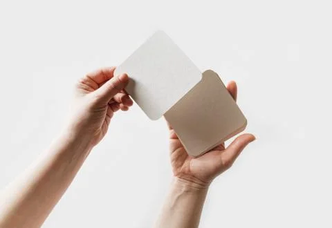 Beer coasters in hands Stock Photos