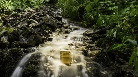 Beer cooled in waterfall spring Video stock 53249055