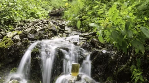 Beer cooled in waterfall spring Stock Footage 53249246