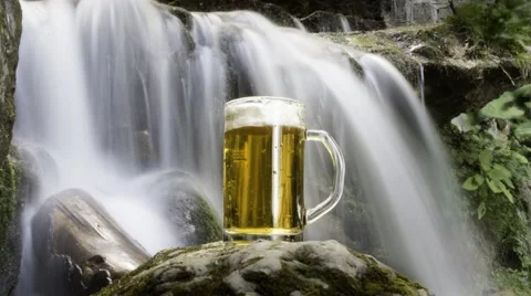 Beer cooled in waterfall spring Stock Footage 54445812