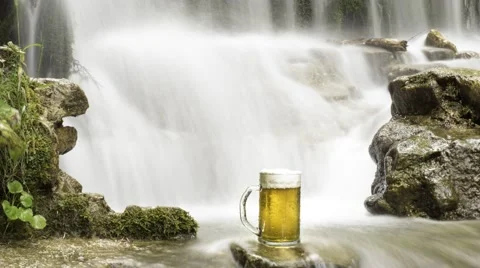 Beer cooled in waterfall spring Video stock 54446631