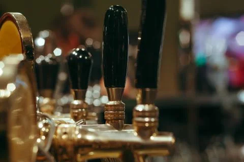 Beer Cranes row in the bar selective focus Stock Photos