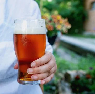 Beer drinking  at the outdoor table Stock Photos