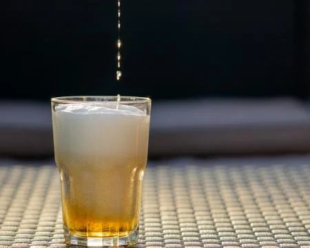 Beer drop falling down to the glass. Copy space Stock Photos