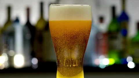 Beer on empty rosy background. Golden liquid stream 3d realistic footage. Stock Footage 265838122