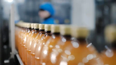 Beer-filled plastic bottles move along the conveyor line at the brewery. Stock Footage 122110869
