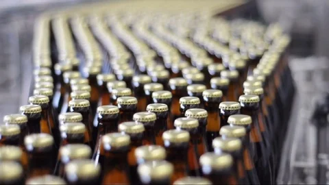 Beer filling in a brewery - conveyor belt with bottles in a food factory Stock Footage
