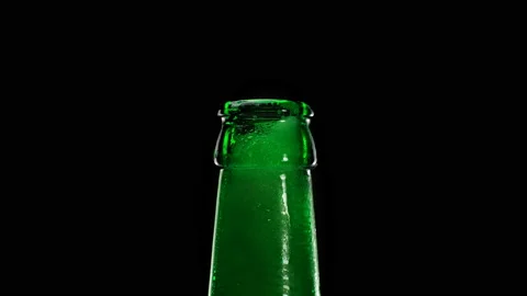 Beer foam escapes from bootle on black background Video stock 162106701
