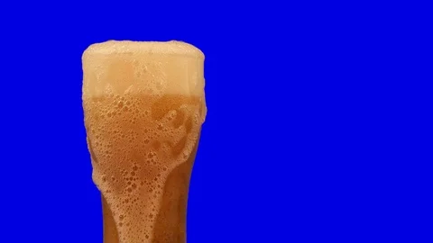 Beer foam flows down from a beer glass. Stock Footage 117099083