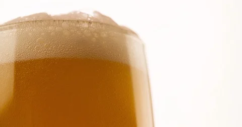 Beer foaming in Glass on white background Closeup 4K Stock Footage 103641002