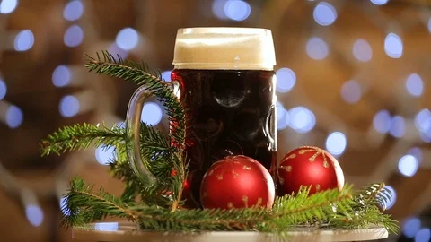 Beer in glass rotate on background with bright lights bokeh. Christmas dark beer Stock Footage 99699573