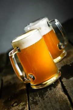 Beer in glasses on rustic background Stock Photos