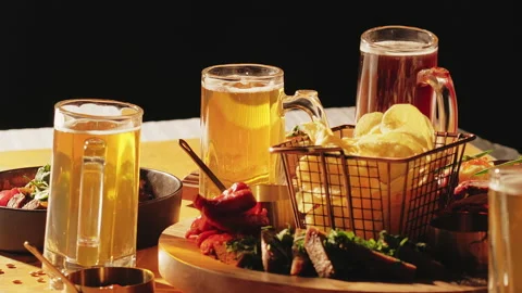 Beer in glasses with set of beer snacks. Assorted beer and deep-fried snacks Stock Footage 239560979